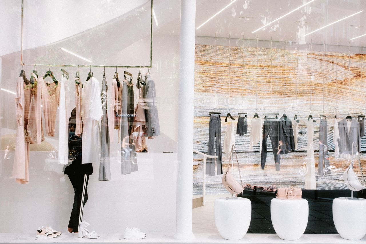 Chic fashion display at a clothing store with stylish reflections.