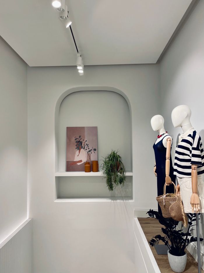 Chic fashion display with stylish mannequins in a contemporary store setting.